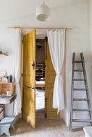 Open yellow wooden door 