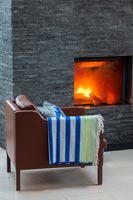 Slate wall fireplace and leather armchair 
