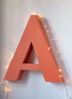 Large orange letter A with fairlights 