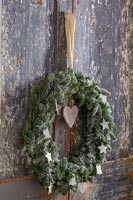 Detail of Christmas wreath on distressed wooden doors 