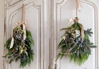 Hanging Christmas bouquets on shabby chic wooden cupboard doors 
