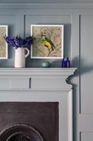 Painting of a bird above fireplace 