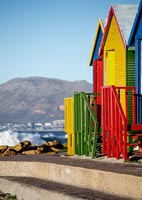Colourful beach huts and coastal view 