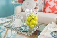 Fruit in glass vase in colourful modern living room 