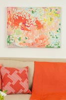 Colourful painting and cushions in modern living room 