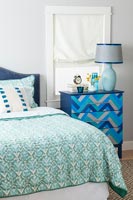 Blue patterned chest of drawers in modern bedroom 