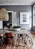 Rustic wooden table and vintage chairs in modern dining room 