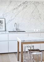 Marble splash back and worktops in white modern kitchen 