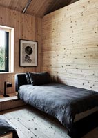 Contemporary twin bedroom in wooden cabin 