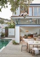 Contemporary outdoor living area with pool - couple and dog on balcony 