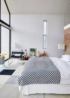 Contemporary bedroom with black and white checked bedspread 