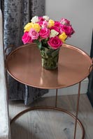 Vase of roses on copper table 