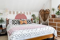 Eclectic bedroom with macrame swing seat 