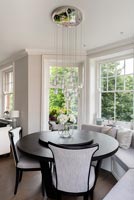 Monochrome dining area with built in window seat 