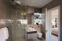 Modern ensuite bathroom with view to bedroom 