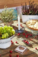 Fruit, berries and potted heather on country dining room table