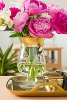 Glass and gold vase full of pink and white flowers 