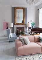 Pink modular sofa in living room with piano 