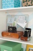Vintage cameras on bookshelf