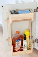 Kitchen cupboard with wooden shelf for cleaning products 