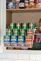 Kitchen cupboard with display of tinned food 