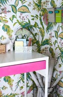 Modern home office with colourful wallpaper and accessories 