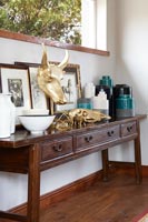 Large wooden sideboard with artwork and ornaments 