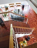 View down modern staircase to open plan living space with parquet floor 