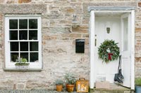 Exterior cottage doorway decorated for Christmas 