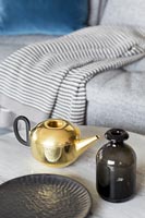 Golden teapot on coffee table