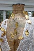Mannequin detail decorated with gold leaves 