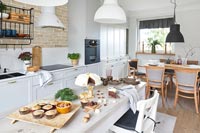 Modern country kitchen with table full of cakes at Christmas 