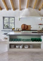 Country kitchen with exposed wooden beams and concrete floor 