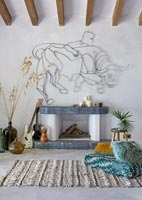 Fireplace with Bull sculpture on wall, guitars and rug - modern country living room
