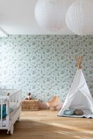 Play tippee in childrens bedroom with floral wallpaper 