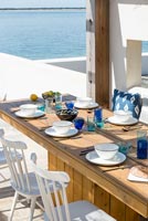 Dining area on decking overlooking the sea