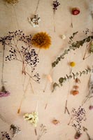 Dried flowers displayed on hessian wall hanging 
