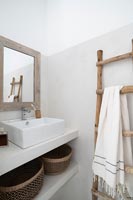 Wooden ladder towel rack in modern country bathroom 