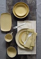 Overhead view of dining table with yellow crockery 