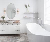 Freestanding bath in modern bathroom with marble floor 