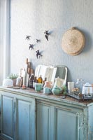 Distressed painted sideboard with kitchen items