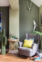 Green painted walls in modern living room 