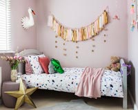 Modern childrens bedroom with tassel wall hanging 