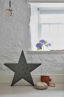 Star shaped light and binoculars case on floor of country living room 