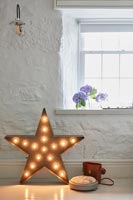 Star shaped lamp on floor of country living room 