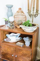 Vintage wooden cabinet with ornaments and plants 