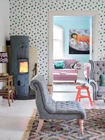 Spotty feature wall with log burning stove in modern living room 
