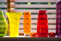 Colourful glassware on windowsill 