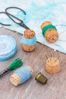 Wine and Champagne corks being used to organise thread and pins