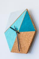 Wall clock made with hexagonal cork board and painted geometric areas